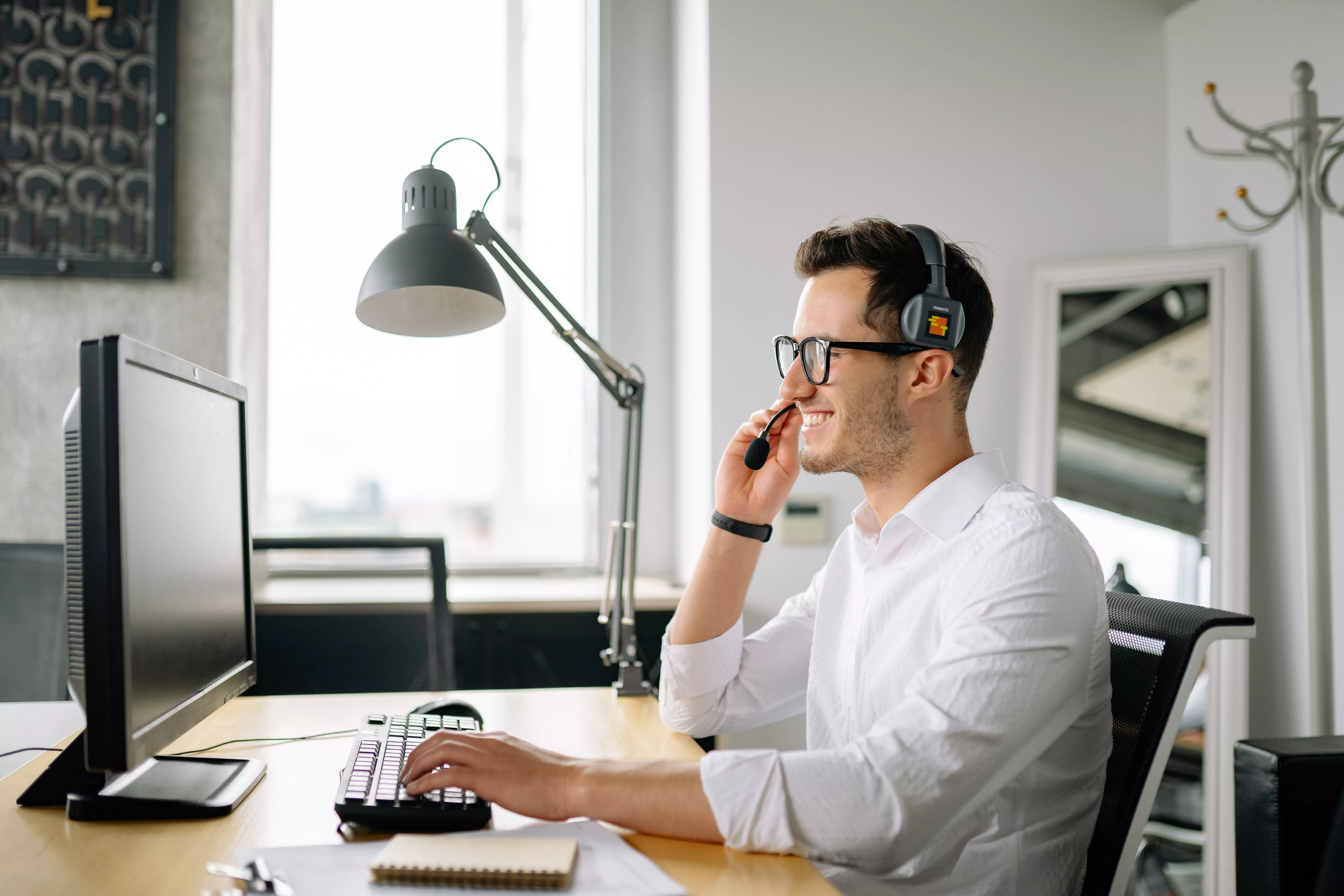 Man wearing headset on computer